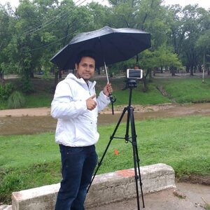 Photo of Sujan Pal taking videos of the river flow during RELAMPAGO to measure streamflow, using the LSPIV method.