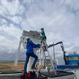 ATMS graduate students Leanne Blind-Doskocil and Eddie Wolff prepare the C-band radar on Wheels